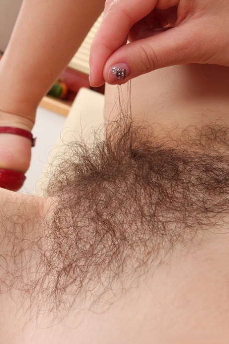 Cute amateur Nessy reveals her hairy pussy and rubs it up close