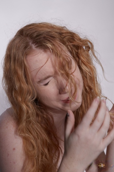 Natural redhead Nicki Blue poses totally naked on top of a medicine ball