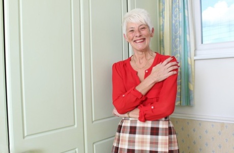 Over 70 Bristish granny takes off her clothes and lingerie striptease style