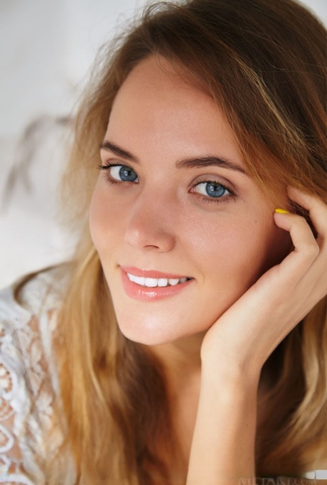 Leggy teen with blue eyes Mango A showcases her shaved pussy in the nude