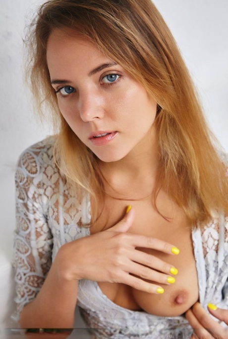 Leggy teen with blue eyes Mango A showcases her shaved pussy in the nude