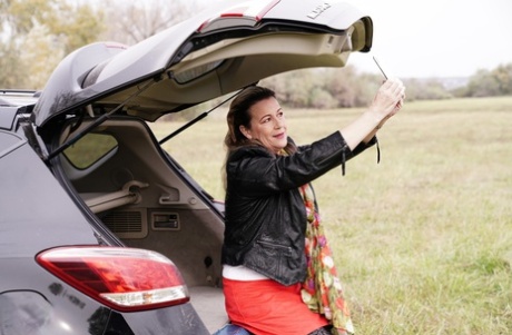 Horny granny Eva Jayne gets cum on her face after a gangbang in a field