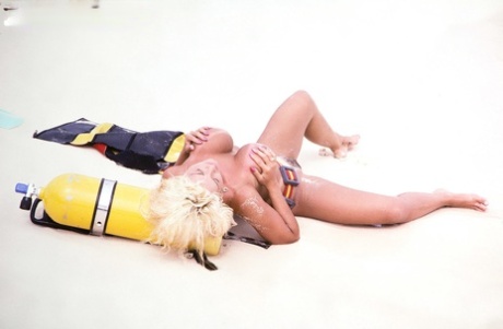 Blonde chick Bethany Bustin flaunts her hooters after removing scuba gear