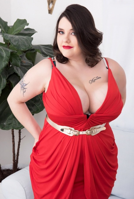 Tattooed BBW Nagini unleashes her giant tits as she takes off a red dress