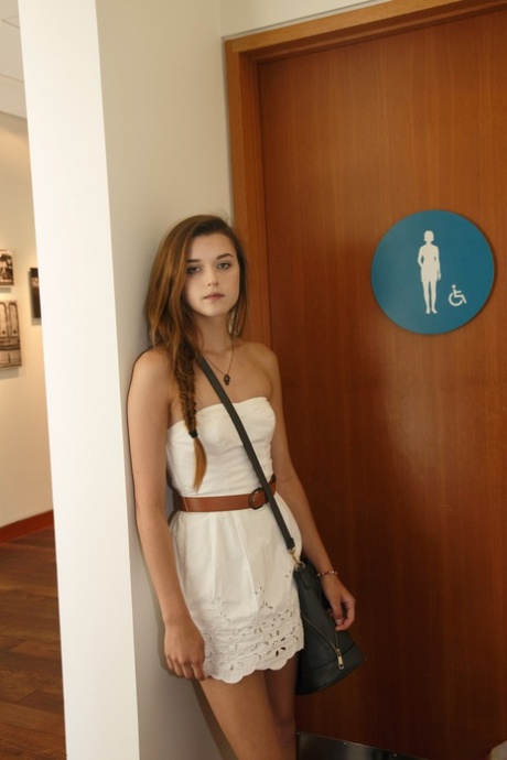 Brunette teen Alex Mae posing pantyless & flashing her tits on the sandy beach