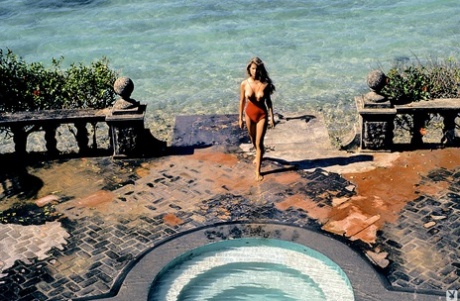 Vintage centerfold Terri Welles baring her big tits and hairy pussy outdoors