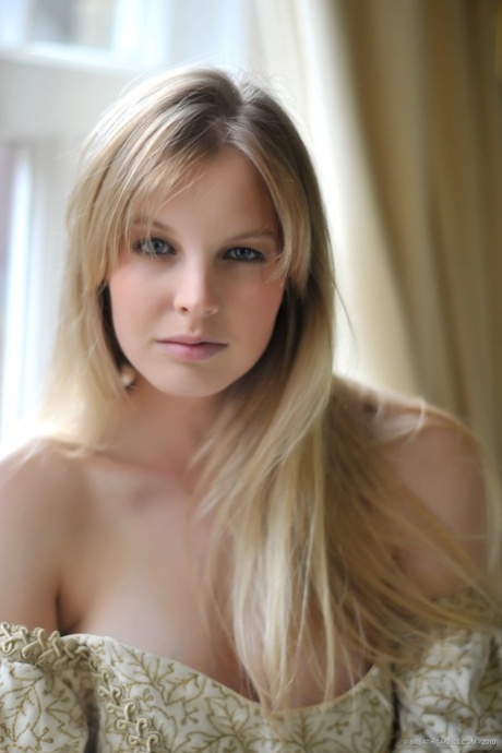 Blonde girl Rose takes off her petticoat to model in a girdle and nylons