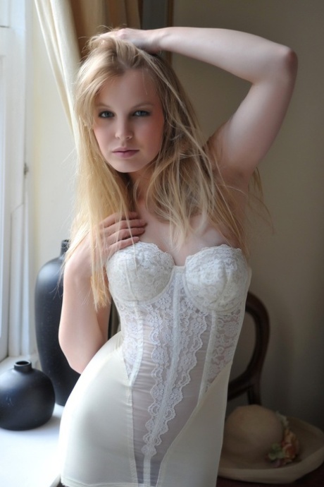 Blonde girl Rose takes off her petticoat to model in a girdle and nylons