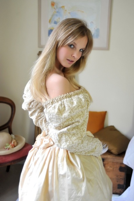 Blonde girl Rose takes off her petticoat to model in a girdle and nylons