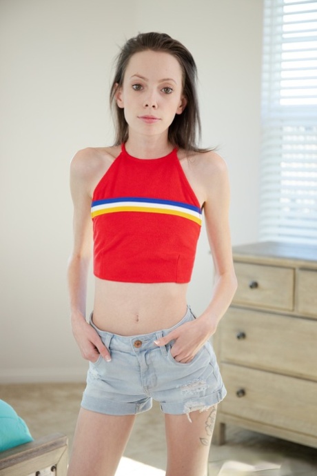 Skinny babe Aria Haze strips fully naked and spreads her little shaved pussy