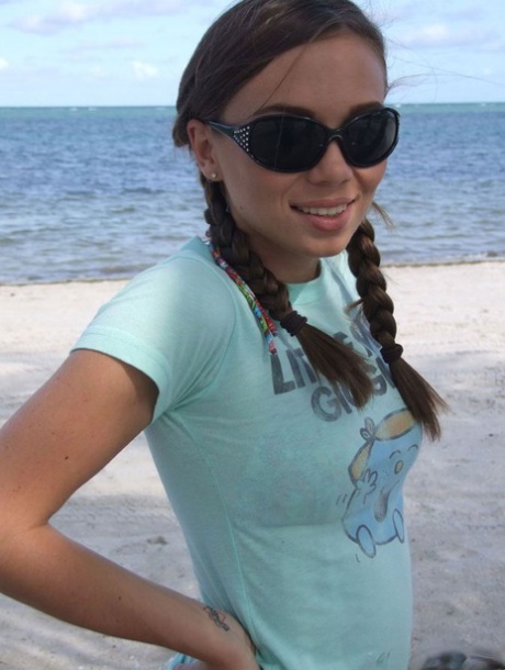 Sweet teen girl Alexiss Capri showing off nice ass in thong underwear on beach