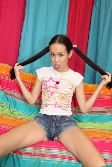 Asian nubile teen Amai Liu spreads legs and plays with her tiny pussy