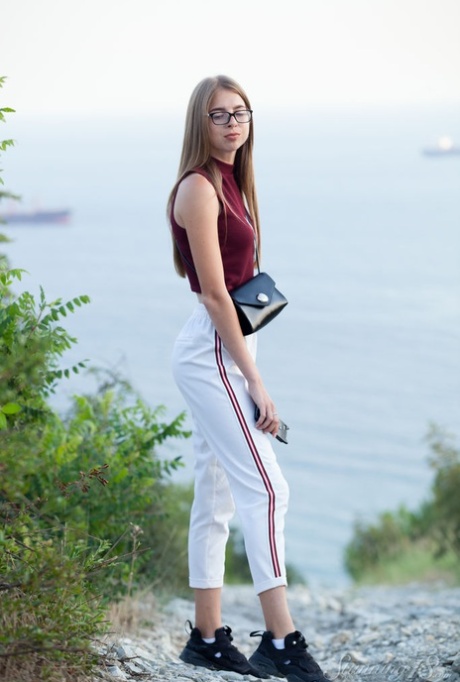 18-year-old Mistri exposes her nice ass getting totally naked near the water