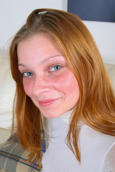 Redheaded beauty Indiana stripping and posing butt naked in a solo