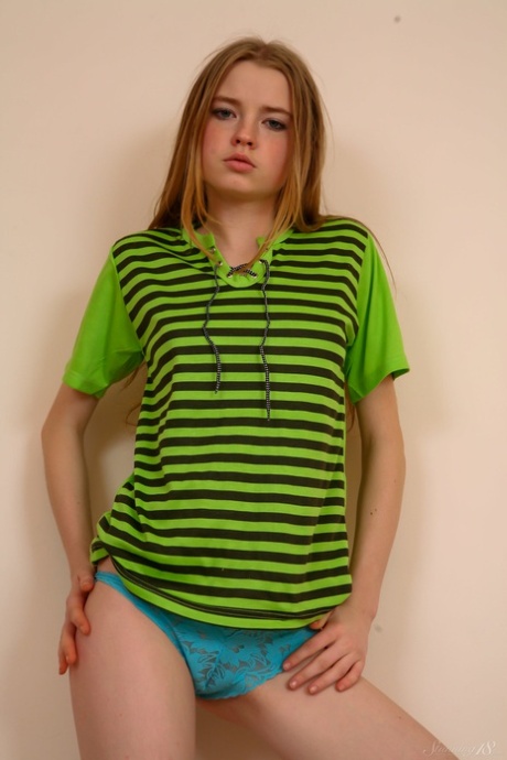 Cute amateur babe Avril A strips to her panties & socks & shows her small tits