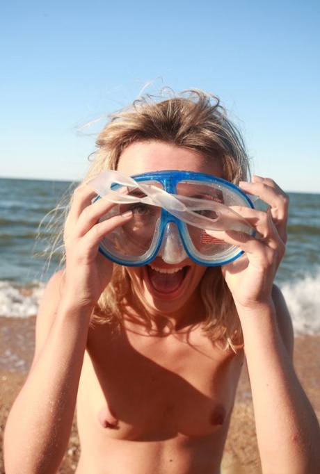 18-year-old blonde Nicole V poses nude on a beach in snorkeling gear