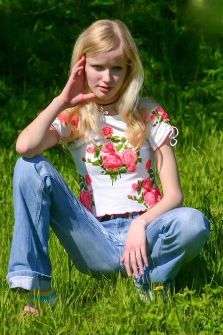 Pretty blonde teen Yana F shows off her petite naked body outdoors