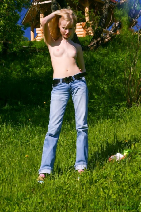 Pretty blonde teen Yana F shows off her petite naked body outdoors