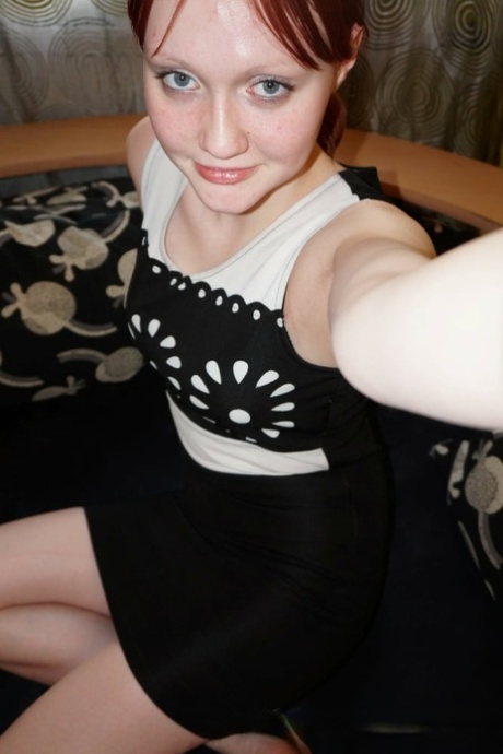 Sexy redhead stripping and posing to takes selfies of her hot naked body