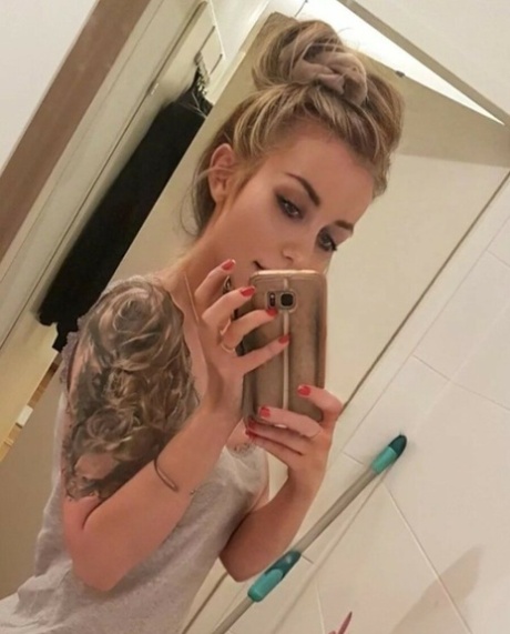 Beautiful tattooed babe shows off her big ass & her juicy tits in the bathroom