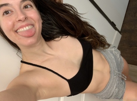 Amateur model holds her bare ass during a series of nude selfies