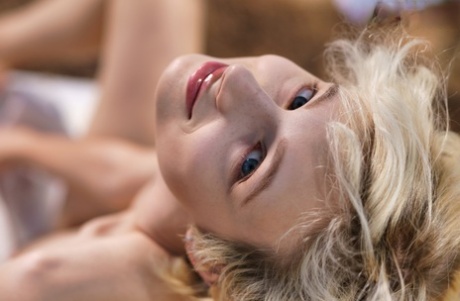 Teen girl with short blonde hair spreads her meaty labia lips in a clearing