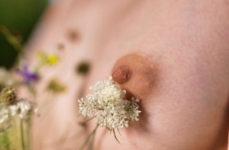 Teen girl with short blonde hair spreads her meaty labia lips in a clearing