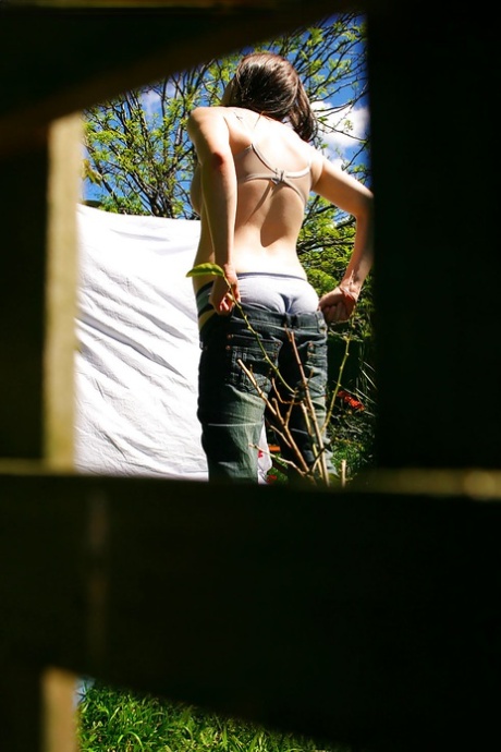 Hidden voyeur spies on naked girl getting dressed outdoors