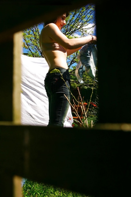 Hidden voyeur spies on naked girl getting dressed outdoors