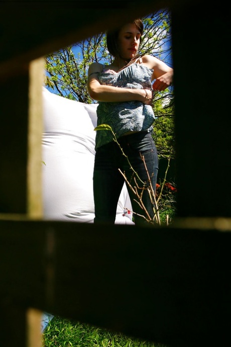 Hidden voyeur spies on naked girl getting dressed outdoors