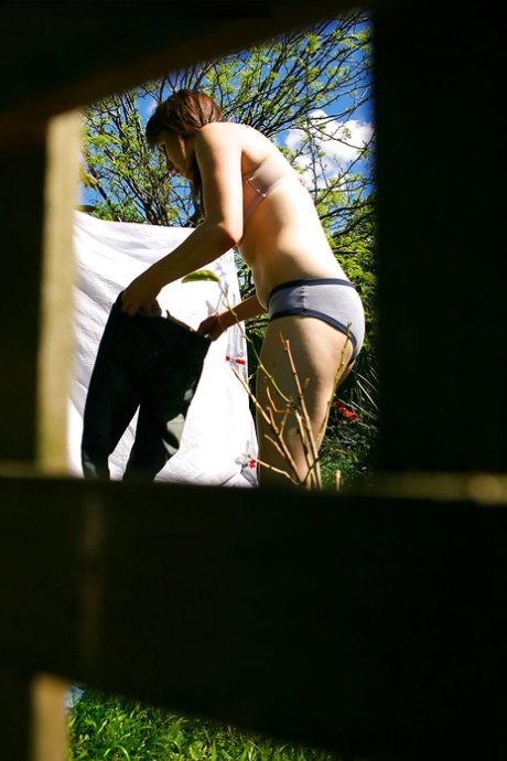 Hidden voyeur spies on naked girl getting dressed outdoors