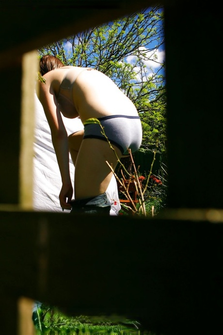 Hidden voyeur spies on naked girl getting dressed outdoors