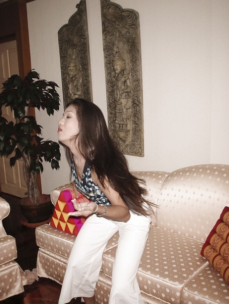 Hot thai MILF slipping off her clothes and fingering her twat