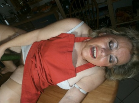 Horny oma Caro pleasures her pussy with a wooden spoon and a cucumber