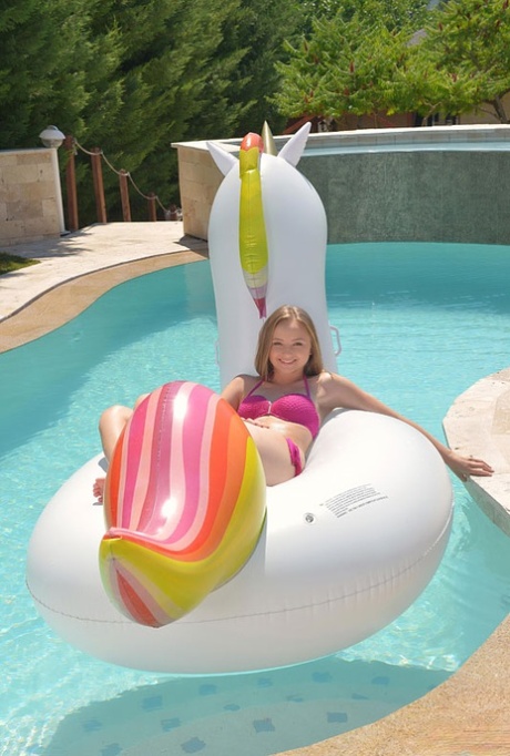 Blonde girl Lady Bug lounges in the pool before fucking on the patio