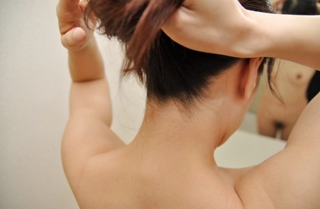 Asian brunette with small tits Yoshie washing her pussy