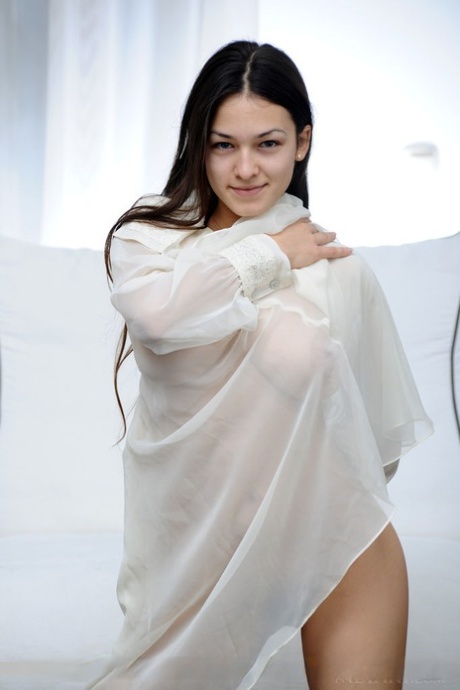 Erotic brunette Sofi A opens wide to give a good look at her hairy muff