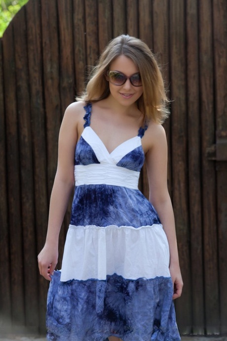 Smiley faced teen Nikia A removing dress for outdoor glamour spread